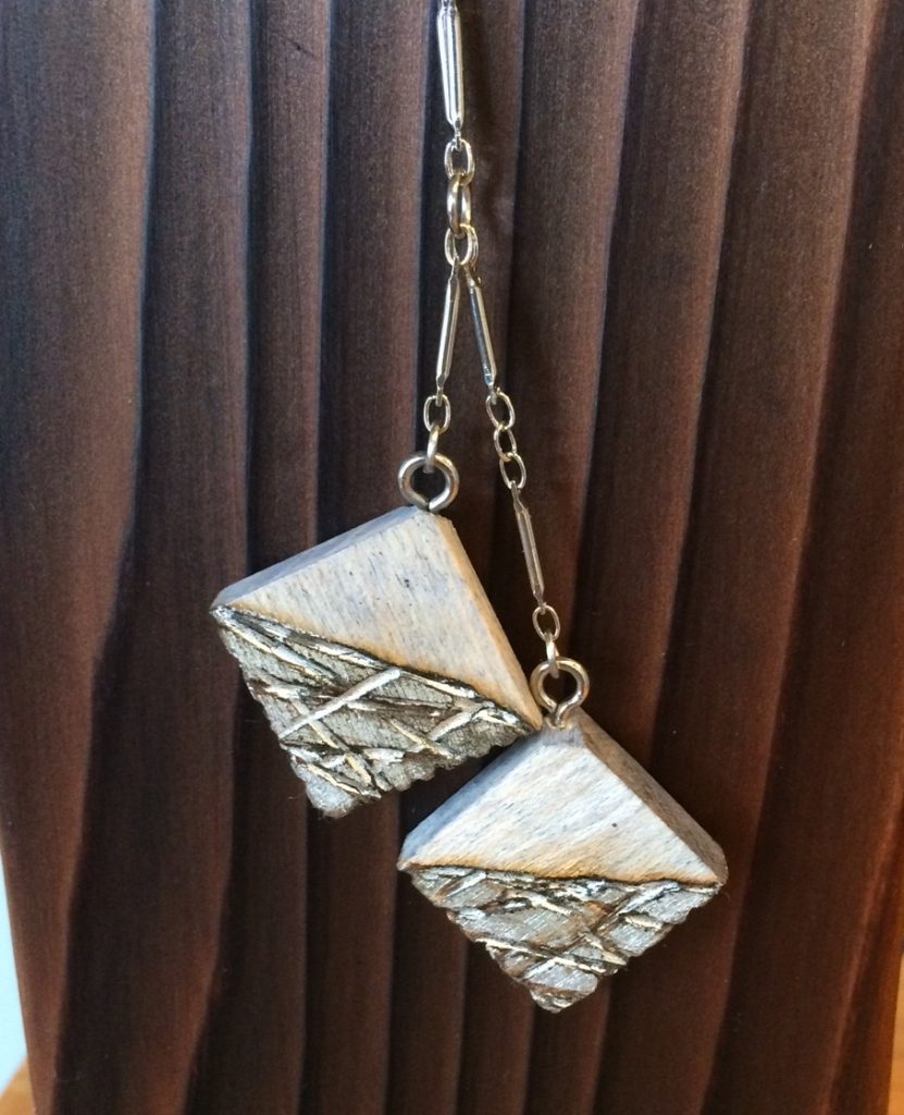 Silver pendant on char